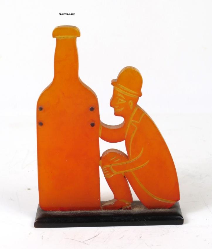 Stragne Marblized Bakelite Figure Bowing to a Liquor Bottle Temperance?